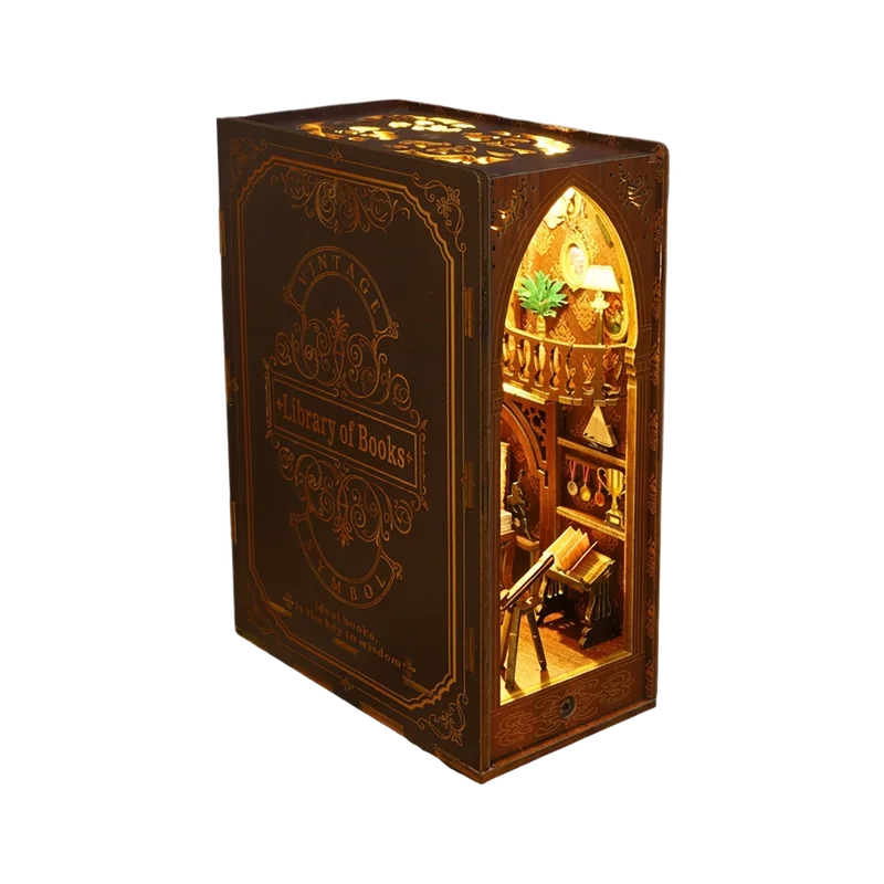 The Library book nook: a book-shaped miniature that opens into a warmly lit two-story library with a balcony and telescope.